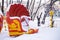 Shell carousel under snow in a closed amusement park in winter