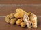 Shell cracked steamed peanut pile on wooden plank table top.