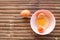 shell with egg and open Eggs in a pink bowl on Bamboo battens. Top view closeup