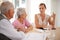 Shell help them understand the complexities. A young businesswoman explains information to an elderly couple.