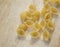 Shell shaped macaroni on wooden cutting board