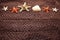 Shell and starfish on brown fishing net and wooden background