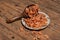 Shelled fresh shrimps on a plate or bowl are on a wood colored table