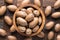 Shelled pecan nuts raw in wooden bowl, top view