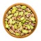 Shelled pistachio kernels in wooden bowl over white