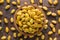 Shelled pistachios, roasted nuts with saffron in wooden bowl, top view