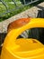 A shellless snail climbing up a small plastic waterer