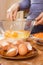 Shells of chicken eggs lie on a saucer in the foreground.