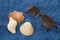 Shells and dark glasses lying on a blue towel.