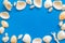 Shells frame and seaside background for blog or desktop on blue table top view mock-up