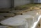 Shelves with aged cheeses. Cheese row