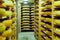 Shelves of aging Cheese on wooden shelves