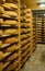 Shelves of aging Cheese on wooden shelves