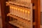 Shelves with cell curlers for the withdrawal of the queen bee in a special locker. Close up, details of beekeeping