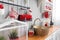 Shelves with dishes. Interior light grey kitchen and red christmas decor. Preparing lunch at home on the kitchen concept