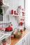 Shelves with dishes. Interior light grey kitchen and red christmas decor. Preparing lunch at home on the kitchen concept