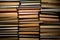 Shelves with old books. Stacks of textbooks with red, blue, green covers and paper sheets with shadow in a dark library