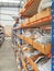 Shelves in a warehouse filled with material in small cardboard containers with material.