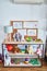 Shelving with lots of  colorful organized toys at kindergarten