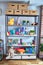 Shelving with lots of  colorful organized toys at kindergarten