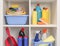 Shelving unit with different cleaning supplies and tools on shelves