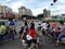 Shenzhen, China: mothers carry children on electric bicycles at traffic junctions