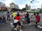 Shenzhen, China: mothers carry children on electric bicycles at traffic junctions