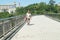 Shenzhen, China: pedestrian bridge, a man picking up waste