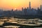 Shenzhen skyline , with skyscrapers and office against fish farm or fish ponds, during dramatic moment in evening