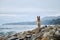 Shepherd dog show breeding black and red color and space for text. German Shepherd on rocky beach. Dog sits on rocks against