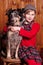 Shepherd girl sitting next to his beloved dog breed border collie. on the farm