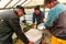 Shepherd preparing milk for cheese making at the farm in Transylvania Roumania