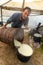 Shepherd preparing milk for cheese making at the farm in Transylvania Roumania