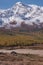 Shepherd`s house ail and herd of cows on ALtai mountain plateau Eshtykel. North Chui ridge is on background. Altai, Russia