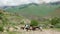 Shepherds grazes cows on the grassland in mountains. Domestic cattle breeding. Shepherd leads a cow in the meadow. rural