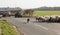 Shepherds herding sheep along public highway.