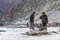 Sherpa carrying load on the frozen river