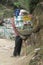 Sherpa porter carry basket in Nepal trekking path