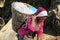 Sherpa porter woman carry heavy loaded basket in Nepal