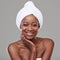 Shes absolutely flawless. Beauty shot of a young woman with a towel around her head posing in studio.