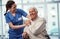 Shes absolutely wonderful. a young female nurse and her senior patient in the old age home.