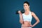 Shes all about toning and strengthening. Studio shot of a fit young woman posing against a blue background.