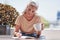 Shes an avid writer. an attractive senior woman enjoying a cup of coffee while writing in her book outside on the