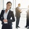 Shes the consumate professional. Cropped portrait of a businesswoman standing a lobby with her colleagues in the