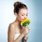 Shes a delicate beauty. Studio shot of a beautiful young woman smelling a sunflower.