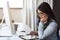 Shes a diligent worker. a young businesswoman sitting at a desk using a digital tablet.