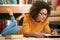 Shes enjoying her required reading. Full length shot of a young woman lying on the floor while studying.