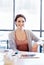 Shes full of ideas. Portrait of an attractive young woman sitting at her desk in an office.