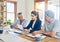 Shes going to help them make their savings last. a mature couple getting advice from their financial consultant at home.