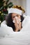 Shes got a case of the Christmas sniffles. Cropped shot of an attractive young woman blowing her nose while wearing a